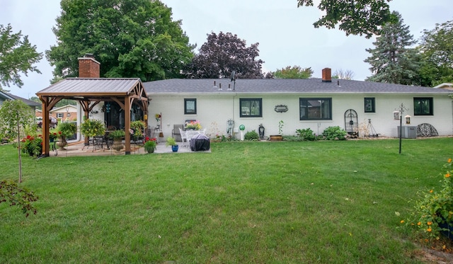 4143 Browning Dr, Saint Joseph, MI 49085 - back of property featuring a chimney, a gazebo, a patio area, a lawn, and cooling unit