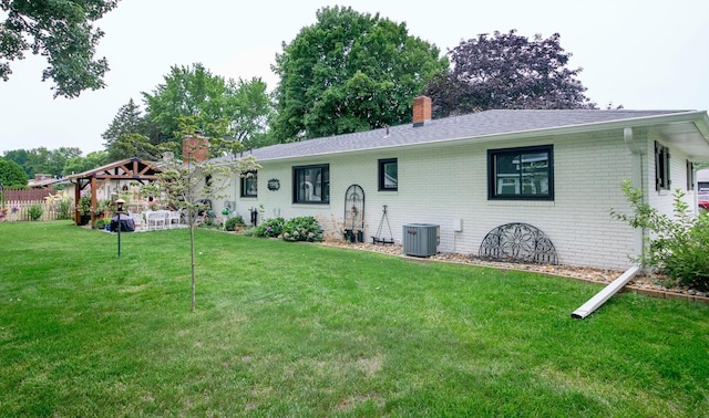 4143 Browning Dr, Saint Joseph, MI 49085 - back of property featuring a chimney, a gazebo, brick siding, central air condition unit, and roof with shingles