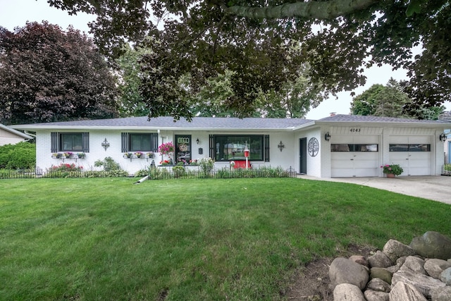 4143 Browning Dr, Saint Joseph, MI 49085 - ranch-style house with brick siding, a garage, and a front lawn