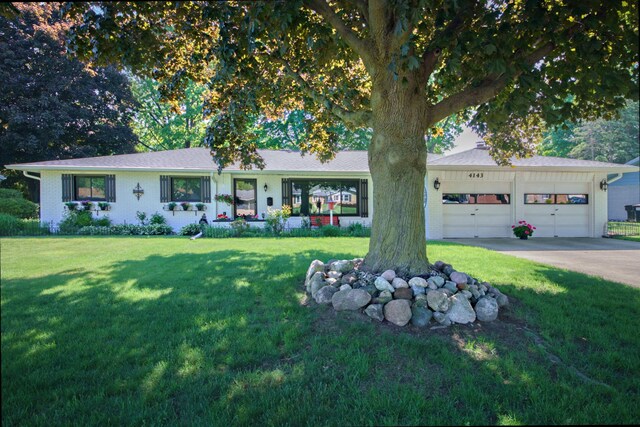 4143 Browning Dr, Saint Joseph, MI 49085 - ranch-style house with a front lawn, a garage, and driveway