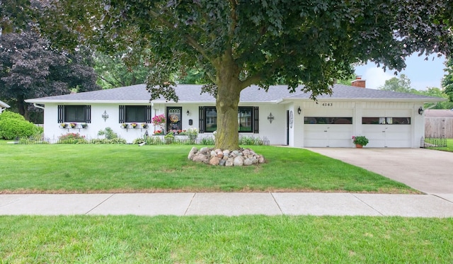 4143 Browning Dr, Saint Joseph, MI 49085 - ranch-style house featuring an attached garage, concrete driveway, a front yard, and a chimney