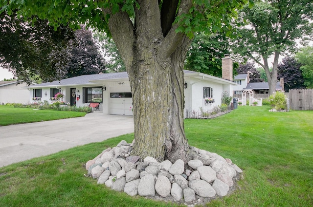 4143 Browning Dr, Saint Joseph, MI 49085 - view of front of property with a garage, a chimney, driveway, and brick siding