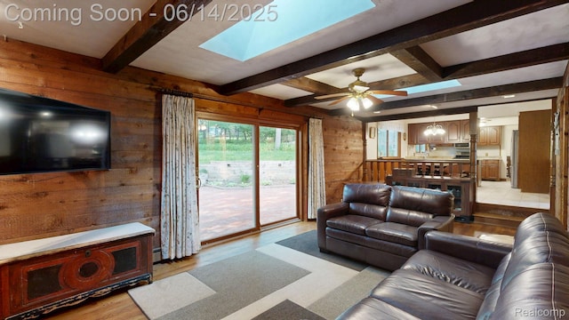 6624 Wellesley Ter, Clarkston, MI 48346 - living room with light wood-style floors, wood walls, a skylight, beamed ceiling, and ceiling fan