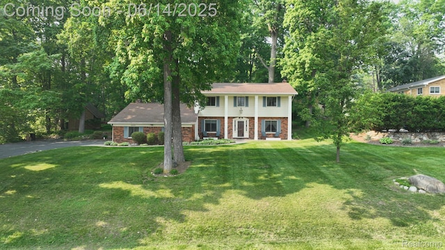 6624 Wellesley Ter, Clarkston, MI 48346 - view of front facade with brick siding and a front yard