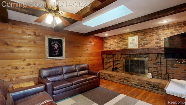 6624 Wellesley Ter, Clarkston, MI 48346 - living area featuring beam ceiling, wood finished floors, a fireplace, wooden walls, and a skylight
