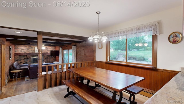 6624 Wellesley Ter, Clarkston, MI 48346 - dining area with wood walls, a wainscoted wall, a chandelier, beam ceiling, and brick wall