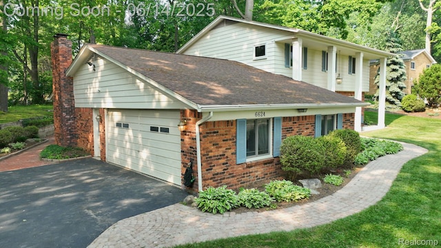 6624 Wellesley Ter, Clarkston, MI 48346 - view of side of home with brick siding, a shingled roof, a chimney, and asphalt driveway