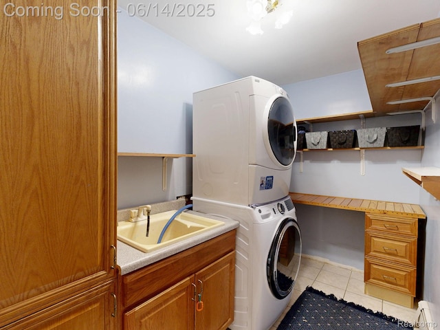 6624 Wellesley Ter, Clarkston, MI 48346 - laundry area featuring stacked washer / dryer, light tile patterned floors, baseboard heating, and cabinet space