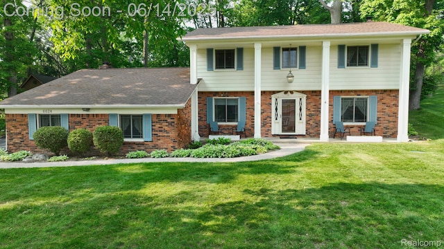 6624 Wellesley Ter, Clarkston, MI 48346 - view of front of property with brick siding, a front lawn, and a shingled roof