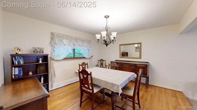 6624 Wellesley Ter, Clarkston, MI 48346 - dining space with a chandelier, a baseboard heating unit, and light wood-style flooring