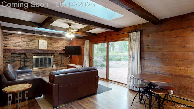 6624 Wellesley Ter, Clarkston, MI 48346 - living room featuring beamed ceiling, wood finished floors, wood walls, a skylight, and a brick fireplace