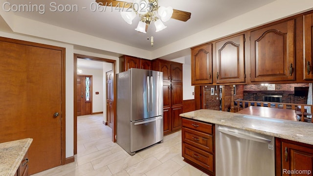 6624 Wellesley Ter, Clarkston, MI 48346 - kitchen featuring stainless steel appliances, backsplash, a ceiling fan, light stone counters, and brown cabinetry