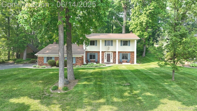 6624 Wellesley Ter, Clarkston, MI 48346 - view of front of home with brick siding and a front lawn