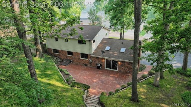 6624 Wellesley Ter, Clarkston, MI 48346 - back of property with a patio and brick siding