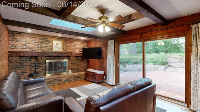 6624 Wellesley Ter, Clarkston, MI 48346 - living area with beamed ceiling, wood finished floors, a fireplace, ceiling fan, and brick wall