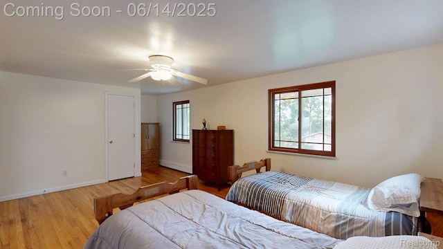 6624 Wellesley Ter, Clarkston, MI 48346 - bedroom with multiple windows, wood finished floors, a baseboard heating unit, and a ceiling fan