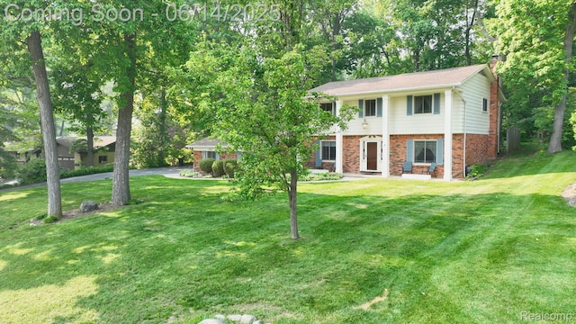 6624 Wellesley Ter, Clarkston, MI 48346 - view of front of house featuring brick siding, a chimney, and a front lawn