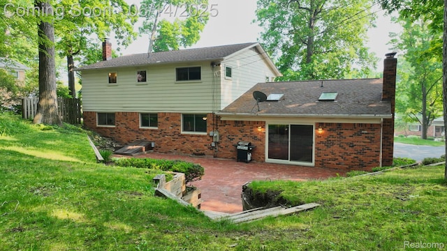 6624 Wellesley Ter, Clarkston, MI 48346 - rear view of property with a chimney, a patio area, a yard, and brick siding