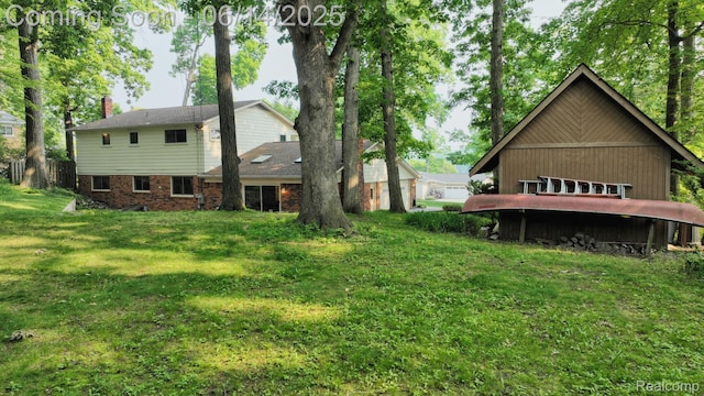 6624 Wellesley Ter, Clarkston, MI 48346 - back of property featuring a lawn and brick siding
