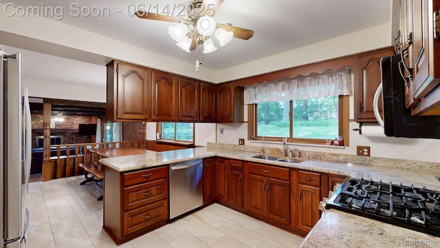 6624 Wellesley Ter, Clarkston, MI 48346 - kitchen with stainless steel appliances, a ceiling fan, a peninsula, and light stone countertops