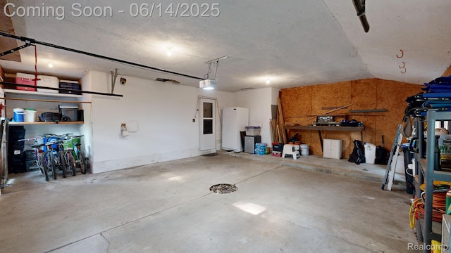 6624 Wellesley Ter, Clarkston, MI 48346 - garage with a garage door opener and freestanding refrigerator