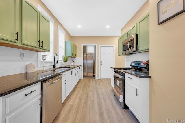 8857 Charlevoix St, Detroit, MI 48214 - kitchen featuring green cabinetry, appliances with stainless steel finishes, a sink, tasteful backsplash, and recessed lighting