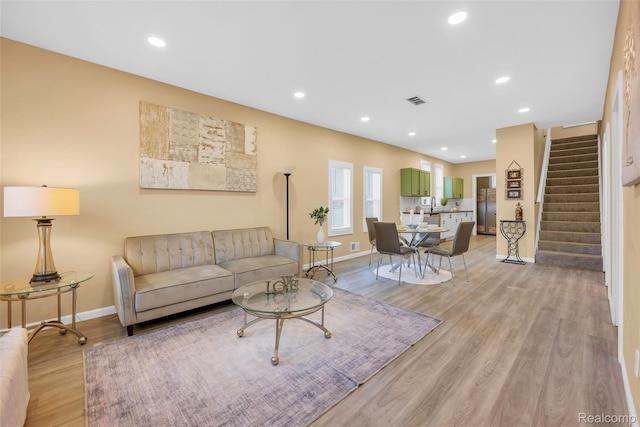 8857 Charlevoix St, Detroit, MI 48214 - living area with stairway, baseboards, light wood-style floors, and recessed lighting