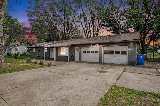 15765 Mason St, Union, MI 49130 - view of front of house with metal roof, concrete driveway, an attached garage, and brick siding