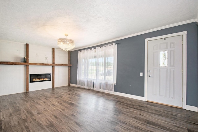 15765 Mason St, Union, MI 49130 - unfurnished living room featuring a textured ceiling, healthy amount of natural light, a chandelier, dark wood-type flooring, and ornamental molding