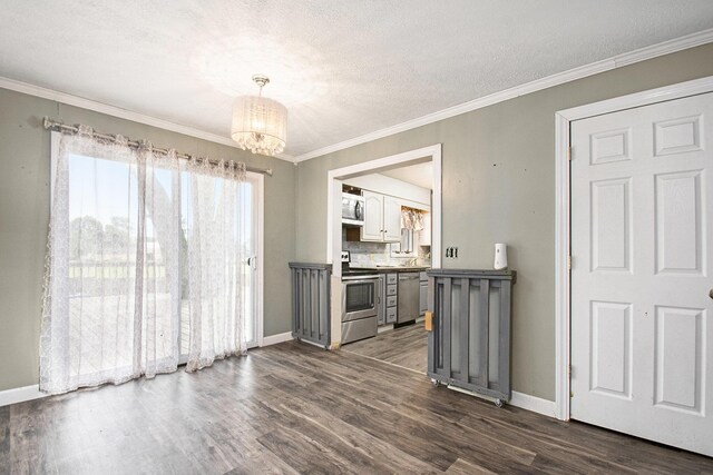 15765 Mason St, Union, MI 49130 - kitchen featuring appliances with stainless steel finishes, a chandelier, dark wood-style flooring, baseboards, and ornamental molding