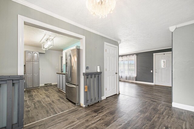 15765 Mason St, Union, MI 49130 - kitchen with stainless steel fridge, a textured ceiling, dark wood finished floors, baseboards, and crown molding