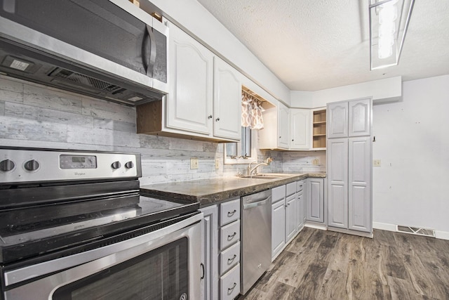 15765 Mason St, Union, MI 49130 - kitchen with stainless steel appliances, white cabinets, a sink, dark wood finished floors, and open shelves