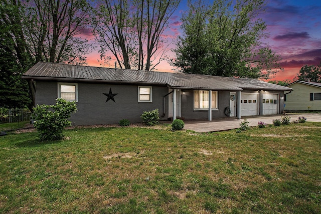 15765 Mason St, Union, MI 49130 - ranch-style home featuring metal roof, a garage, driveway, a lawn, and brick siding