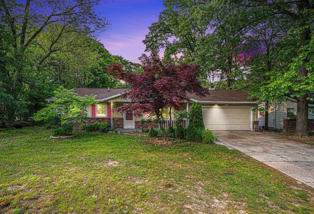 81 Dunton Ave, Holland, MI 49424 - view of property hidden behind natural elements with a garage, concrete driveway, and a front yard
