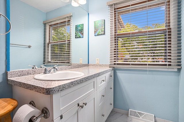 81 Dunton Ave, Holland, MI 49424 - bathroom featuring vanity, marble finish flooring, and baseboards
