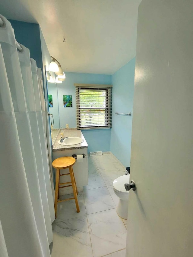 81 Dunton Ave, Holland, MI 49424 - full bath featuring marble look tiles, vanity, toilet, and a shower