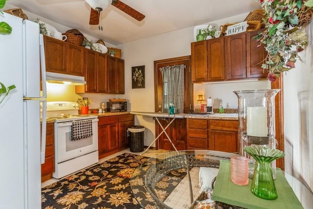 927 Harrison Ave, Saint Joseph, MI 49085 - kitchen featuring white appliances, a ceiling fan, under cabinet range hood, and light countertops