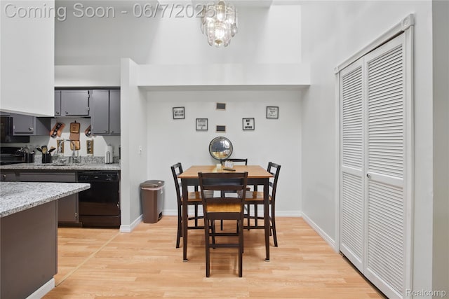 1332 Shoemaker Dr Unit 1332, Belleville, MI 48185 - dining area with light wood finished floors, baseboards, and a chandelier