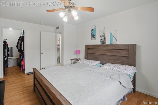 1332 Shoemaker Dr Unit 1332, Belleville, MI 48185 - bedroom with light wood-style flooring, a walk in closet, a closet, and a ceiling fan