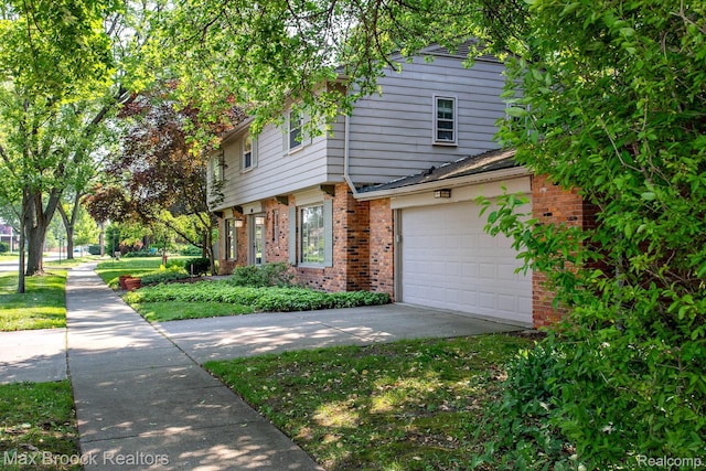 8019 Concord Rd, Huntington Woods, MI 48070 - view of front of home featuring brick siding, a garage, and concrete driveway