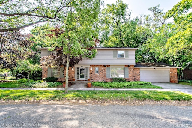 8019 Concord Rd, Huntington Woods, MI 48070 - view of front of home with brick siding, a garage, and concrete driveway