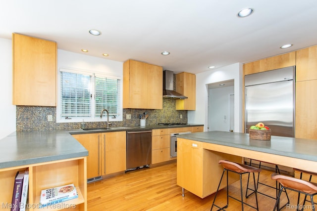 8019 Concord Rd, Huntington Woods, MI 48070 - kitchen with appliances with stainless steel finishes, wall chimney range hood, a breakfast bar, light wood-style floors, and tasteful backsplash
