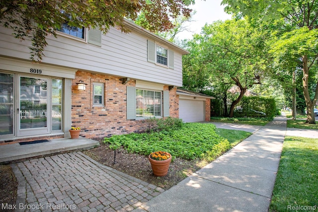 8019 Concord Rd, Huntington Woods, MI 48070 - view of front of property with brick siding, concrete driveway, and a garage