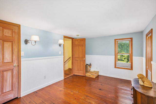 5700 Dexter Townhall Rd, Dexter, MI 48130 - empty room featuring wainscoting, wood-type flooring, stairway, and baseboards