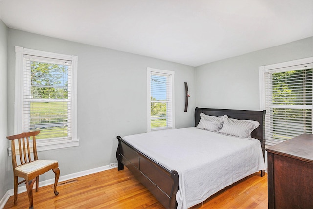 5700 Dexter Townhall Rd, Dexter, MI 48130 - bedroom featuring multiple windows and light wood-style floors