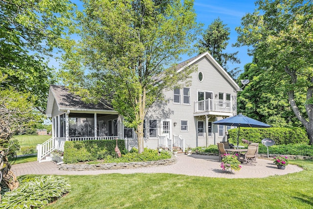 5700 Dexter Townhall Rd, Dexter, MI 48130 - back of property with a sunroom, a balcony, a yard, and a patio area