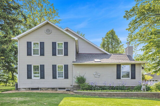 5700 Dexter Townhall Rd, Dexter, MI 48130 - view of front of property with a chimney, a front lawn, a shingled roof, and central AC unit