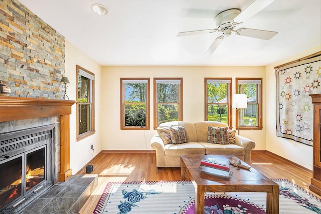 5700 Dexter Townhall Rd, Dexter, MI 48130 - living room with a large fireplace, wood finished floors, baseboards, and a ceiling fan