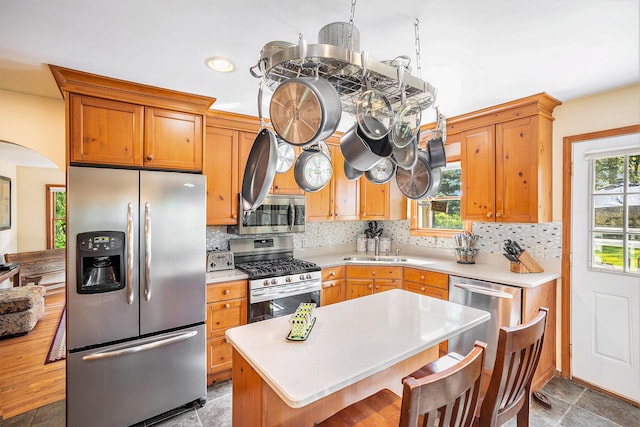 5700 Dexter Townhall Rd, Dexter, MI 48130 - kitchen with appliances with stainless steel finishes, light countertops, plenty of natural light, and decorative backsplash