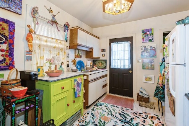 817 Harrison Ave, Saint Joseph, MI 49085 - kitchen featuring green cabinets, freestanding refrigerator, a chandelier, a sink, and light wood-style floors